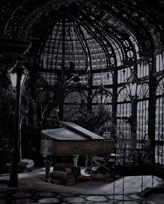 a grand piano in an ornate room with glass walls