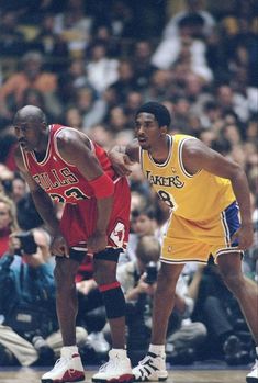 two basketball players standing next to each other