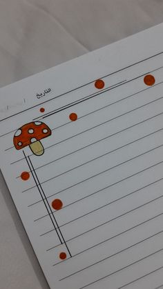 a piece of lined paper with an image of a mushroom on it and red dots