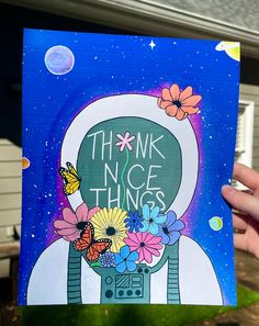 a person holding up a card with the words think nice things on it and flowers