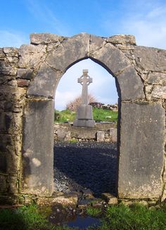 an old stone arch with a cross in it