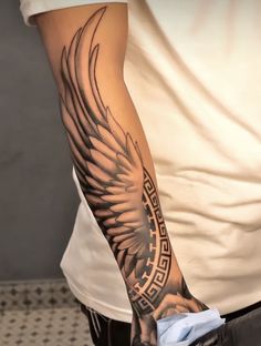 a man's arm with an eagle tattoo on it