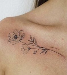 a close up of a woman's shoulder with flowers on it and the word love written in cursive writing