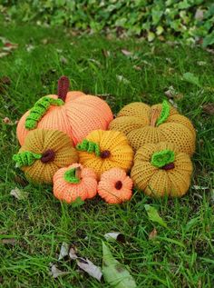 knitted pumpkins and gourds sitting in the grass