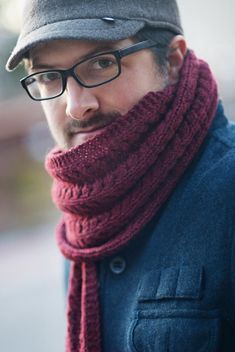 a man wearing glasses and a knitted scarf