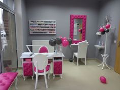 a room decorated in pink and white with balloons