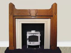 a white stove sitting in a fireplace next to a wall