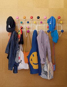 a coat rack with hats, umbrellas and other items hanging on it's hooks