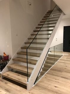 a staircase with glass railing and wooden steps