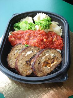 a plastic container filled with meat and veggies