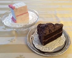 two slices of chocolate cake on plates with lace doily and one slice has been cut