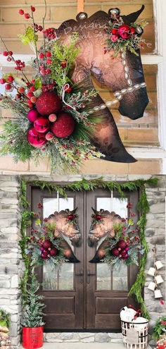 two christmas wreaths on the front door of a house, one with a horse head