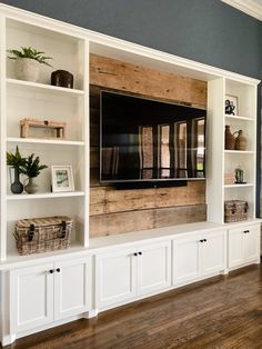 an entertainment center with built in bookshelves and baskets on the bottom shelf is shown