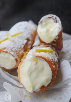 several pastries with lemons and powdered sugar on them