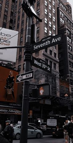 the street sign is clearly visible for all to see on this busy city street in new york