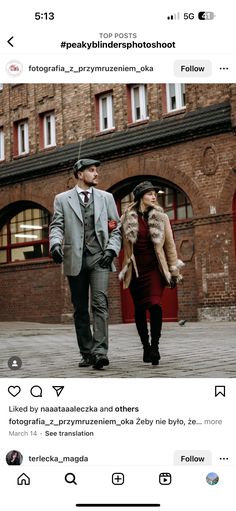 two people are walking down the street in front of some buildings and one is wearing a suit