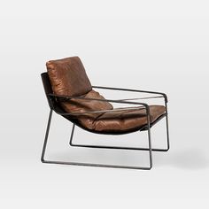 a brown leather chair sitting on top of a metal frame