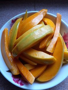 a white bowl filled with sliced up oranges