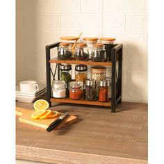 a kitchen counter with spices and condiments on the top, along with a cutting board