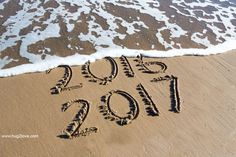 the word 2012 is written in the sand at the beach