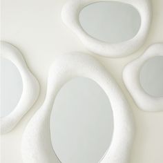 three white circular mirrors sitting on top of a table