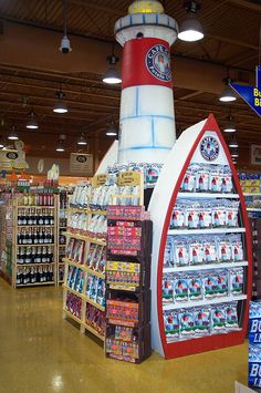 the inside of a grocery store with various items on display and in front of it is a lighthouse