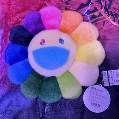 a multicolored stuffed animal with a tag on it