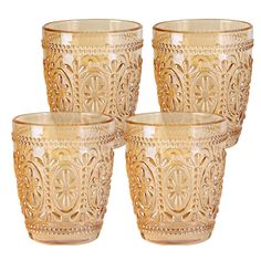 set of four gold glass cups with filigrees on the bottom and sides