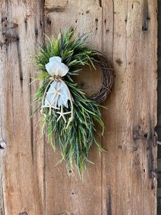 a wreath hanging on the side of a wooden door