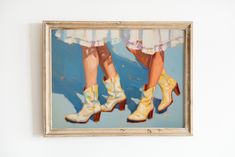 two women's legs in yellow high heeled shoes are seen through a painting