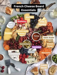 a cheese board is shown with different types of cheeses and other foods on it