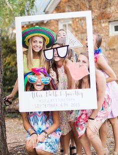 a group of people standing around each other holding up a photo booth sign that says we fell & blob party