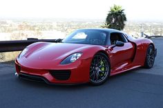 a red sports car parked on the side of a road