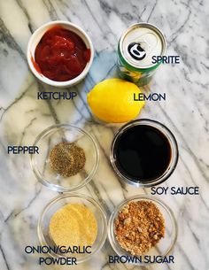 the ingredients to make an apple cider recipe on a marble countertop with lemons, sugar, and ketchup