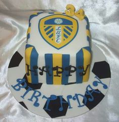 a cake that is sitting on top of a white table cloth with blue and yellow stripes