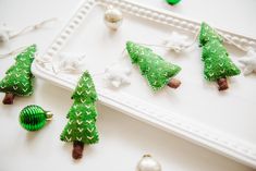 small green christmas trees sitting on top of a white tray