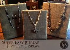 three necklaces are displayed on display in front of linen bags with the words, super easy burlap jewelry display