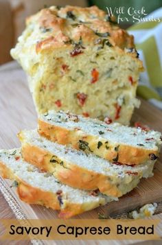 a loaf of savory caprese bread on a cutting board