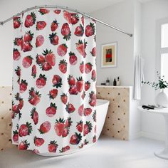 a shower curtain with strawberries on it in a white bathroom next to a bathtub