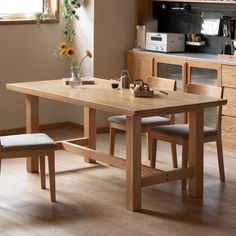 a wooden table and chairs in a room