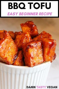 a white bowl filled with tofu sitting on top of a wooden table next to a sign that says easy bbq tofu