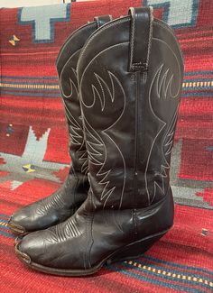 "From Blackbird Vintage of Sedona, Arizona  This is a great pair of authentic Vintage Men's Black Cowboy boots, size 8 D. (Most likely would also fit a ladies 9.5) 12\" tall.  They feature silver metal tips, a very unique heel and are made in Mexico, circa 1950s. measurements: Height: 14 inches, inclusive of 2 3/8 inch heel Heel to toe: 10.5 inches width, widest part of sole: 3 7/8 inches circumference around top of calf: 15\" They are quite distressed and very worn in, with many scuffs and nick Vintage Brown Boots For Western-themed Events, Vintage Black Winter Boots, Fitted Vintage Black Boots, Vintage Goodyear Welted Boots For Fall, Vintage Goodyear Welted Boots With Round Toe, Vintage Fitted Boots With Leather Sole, Vintage Snip Toe Boots For Western-themed Events, Fitted Vintage Boots With Goodyear Welted, Fitted Vintage Boots With Goodyear Welt