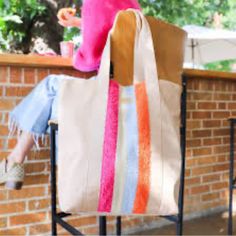 a woman sitting on a chair holding a bag