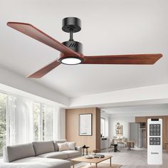 a living room with a couch, coffee table and ceiling fan that is mounted to the ceiling