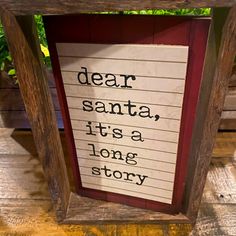 a sign that reads dear santa, it's a long story hanging from a wooden frame