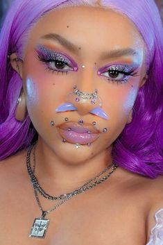 a woman with purple hair and piercings on her face