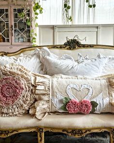 a couch with pillows and flowers on it