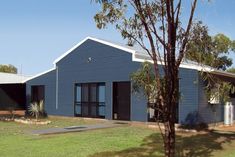 a blue building with two garages on the side