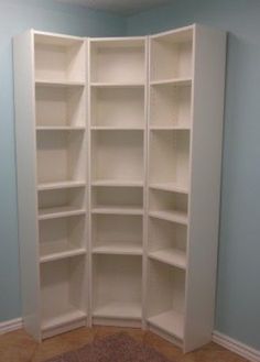 an empty room with blue walls and white bookcases on the wall, carpeted floor