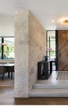 a modern entry way leading to the dining room